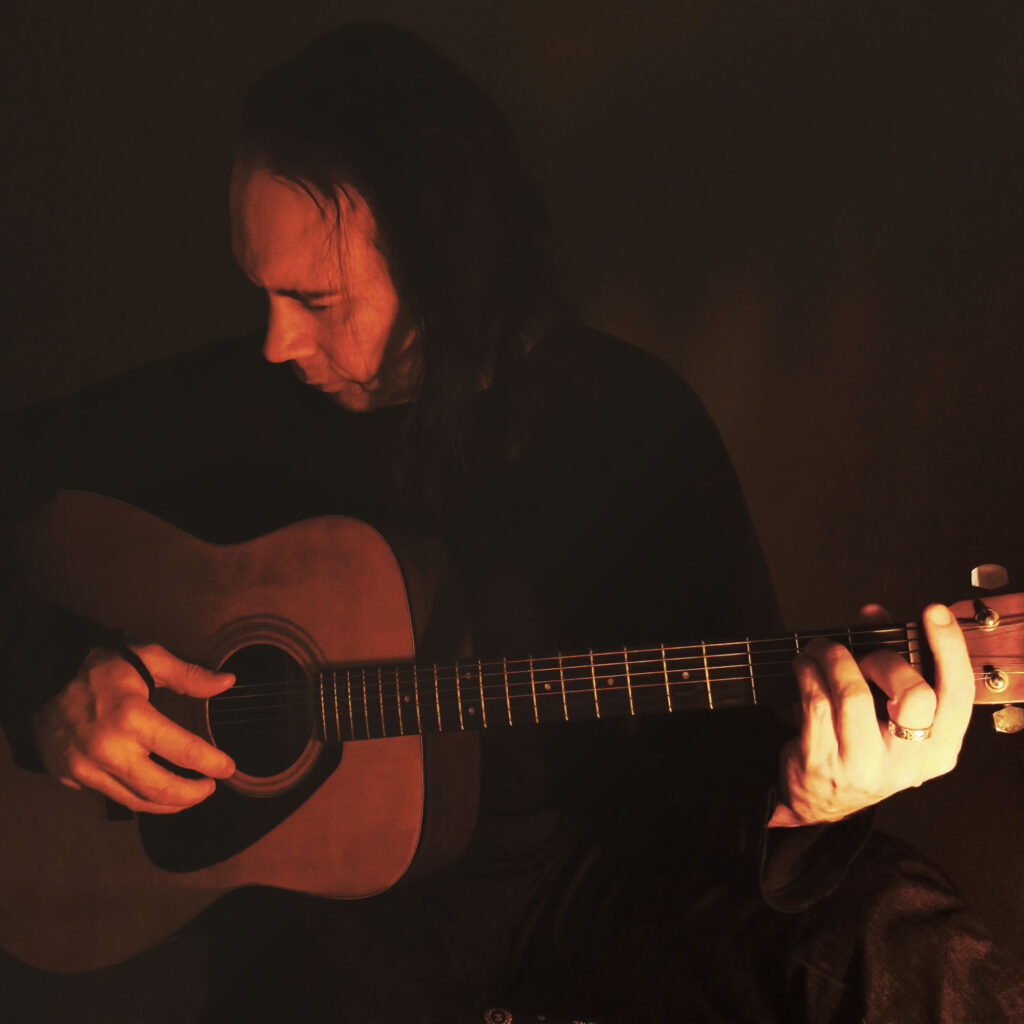 Henrik Flyman playing acoustic guitar